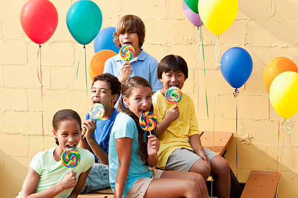 istock Children with lollipops and balloons 184297877