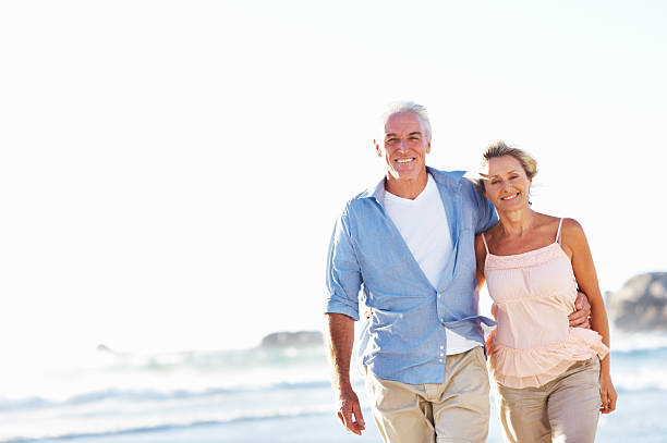 istock Senior couple walking on the beach 184297984