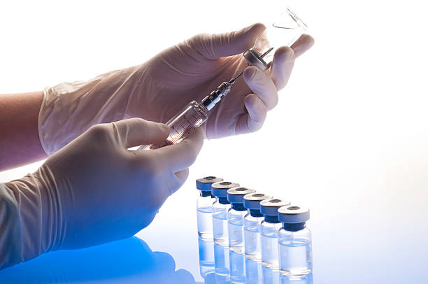 istock A syringe is prepping medications in vials 184298151
