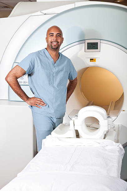istock Healthcare worker preparing MRI scanner 184298444