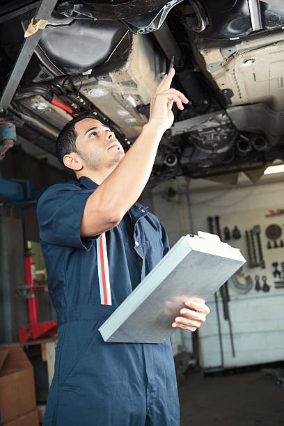 istock Mechanic checking a car with clipboard 184298448