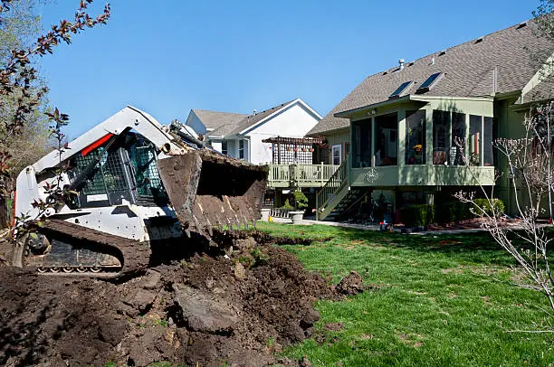 Photo of Bulldozer Scoops Dirt for a New Swimming Pool