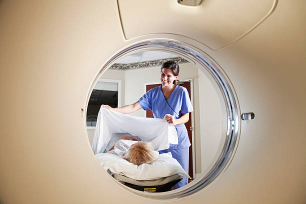 istock Healthcare worker preparing patient for CT scan 184298705