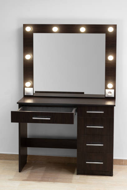 istock Modern dark makeup dressing table with mirror and backlight against a white wall. 1842989635