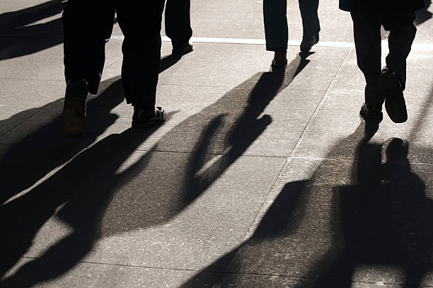 Abstract Shadows of Businessmen Walking stock photo