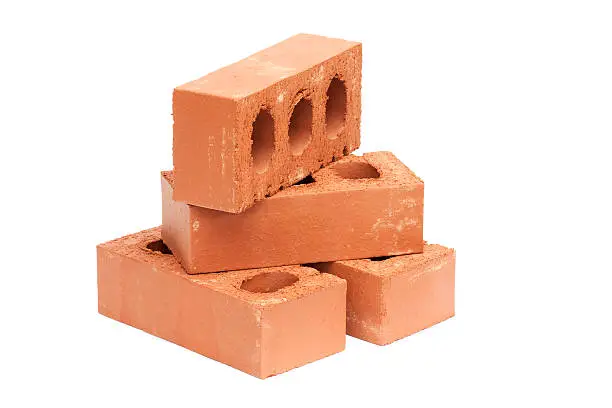 Photo of Four red bricks isolated on white