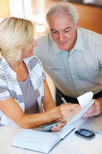 istock Senior couple discussing monthly expenses 184300120