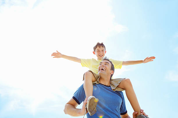 istock Son having fun sitting on his father's shoulders 184300211