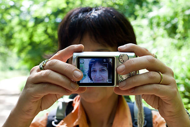 Woman doing a self portraitSee also