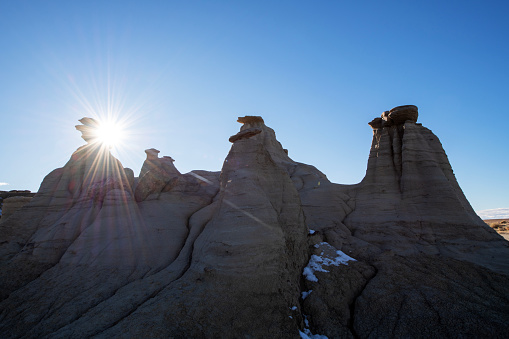 Sun shining through rock formation at Ah-Shi-Sle-Pah Trail in New Mexico, USA