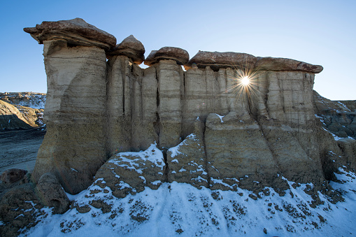 Sun shining through rock formation at Ah-Shi-Sle-Pah Trail in New Mexico, USA