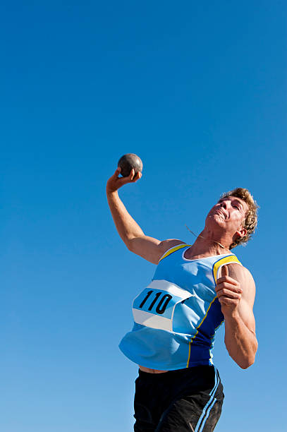 atleta de lançamento do disco masculino em acção - lançamento do peso imagens e fotografias de stock