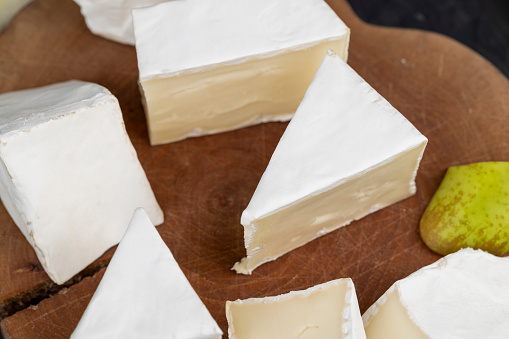 cheese with white mold cut into chunks , preparation of cheese with mold for use in cooking