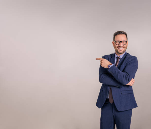 istock Portrait of smiling confident manager aiming at copy space for advertisement on white background 1843005849
