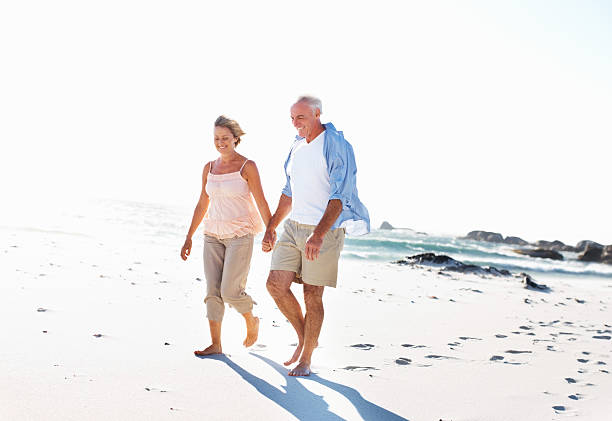istock Senior couple walking on the beach 184300824