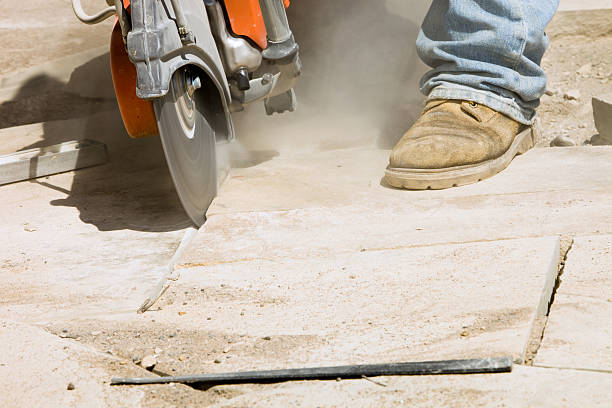 istock Worker Cutting Patio Stone with Gas Powered Saw 184301046