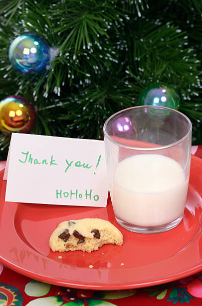 istock Thank you note from Santa Claus, leftover milk and cookie 184301146