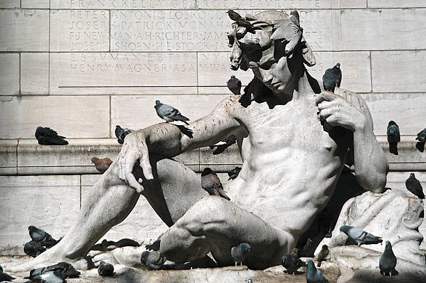 istock Statue of Man Seated with Pigeons 184301294
