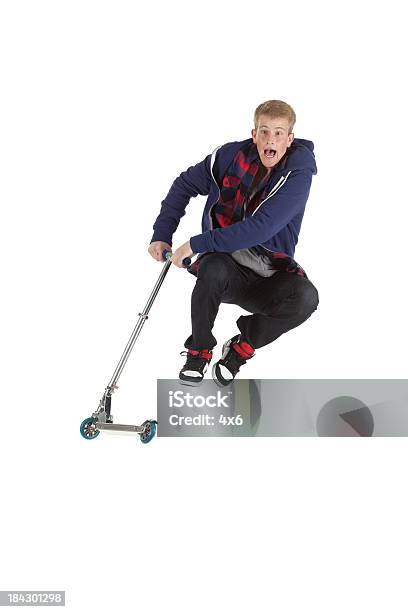 Man Performing Stunts On A Push Scooter Stock Photo - Download Image Now - Push Scooter, Jumping, Humor