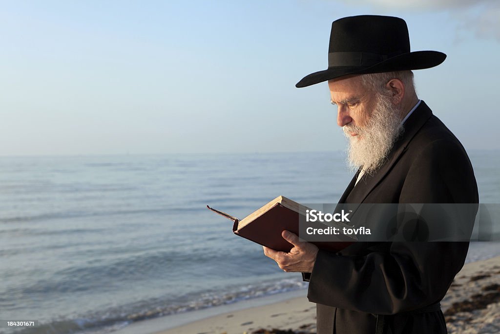 Rabbi praying "Rabbi praying on the beach. Could be used for tashlich for Rosh Hashana, the Jewish New Year." Judaism Stock Photo