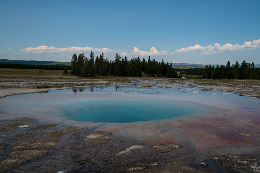 The Grand Prismatic Spring with awesome reflections of the clouds in Yellowstone national park during the summer