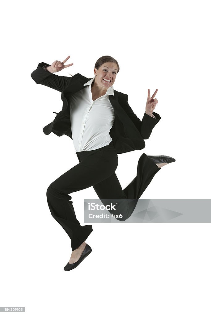 Businesswoman jumping in excitement showing victory sign Businesswoman jumping in excitement showing victory signhttp://www.twodozendesign.info/i/1.png Peace Sign - Gesture Stock Photo