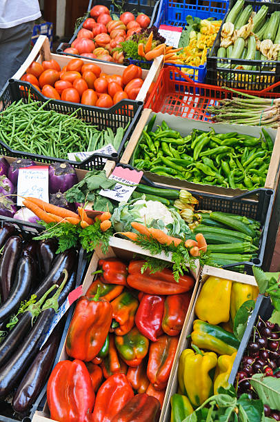 Fresh Local Produce "An outdoor shop of fresh local produce including carrots, peppers, cherries, eggplant, beans, cauliflower and tomatoes on a narrow street in Amalfi, Italy," amalfi food stock pictures, royalty-free photos & images