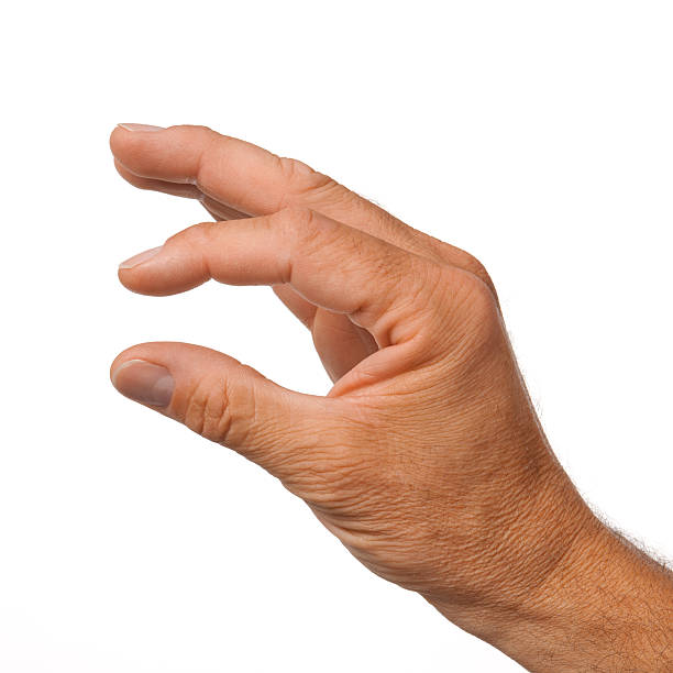 Male hand making the gesture of a little bit stock photo
