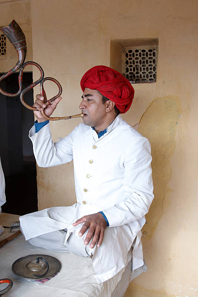 istock Indian musician playing curved trumpet type wind instrument 184302342