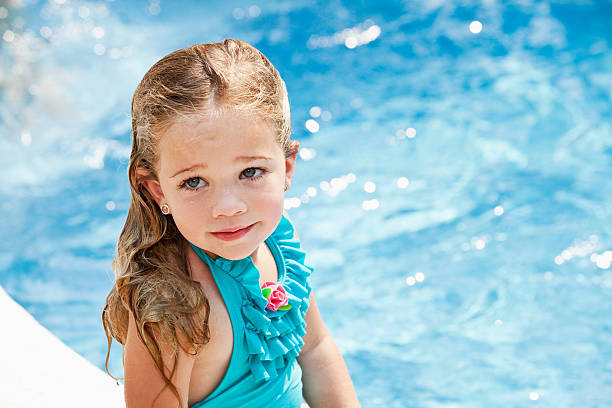 Portrait of little girl in a swimming pool