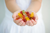 A little girl with a handful of gummy bears