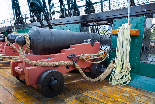 Iron canons are lined up on the deck of the USS Constitution, also known as 