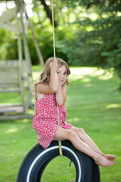 istock Happy Young Girl on a Rope Swing 184302924
