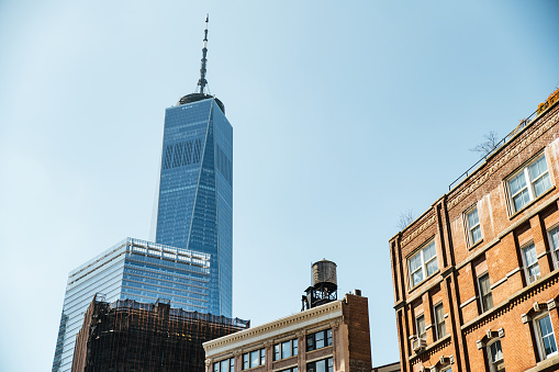 From below of contemporary high rise buildings with glass mirrored windows located on street of modern New York city in Manhattan near Westfield World Trade Center and Oculus