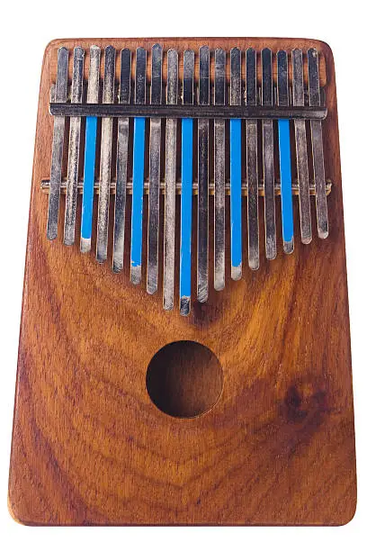 "Frontal view of wooden, used Kalimba thumb piano, isolated on white. Some of metal tines are painted blue. Vertical composition; slight left-to-right lighting. Nice wood grain.Please see some similar pictures from my portfolio:"