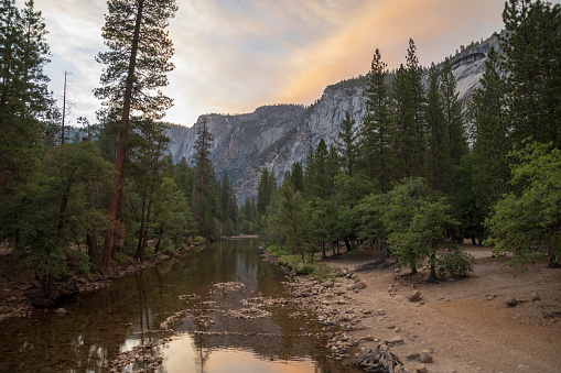 The Merced river in Yosemite valley during the sunset with nice reflections on the river