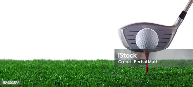 istock Golf club next to golf ball on red tee on grass 184303544