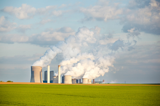 Green Fields In Front Of Industry Skyline