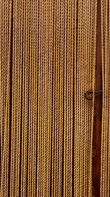 Rope curtain over wooden door