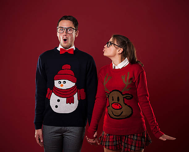 Nerdy woman kissing shocked man Nerdy woman kissing shocked man  vintage nerd with reindeer sweater stock pictures, royalty-free photos & images