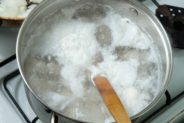 istock Foam from cooking chicken. Boiling water in a pan 1843096063