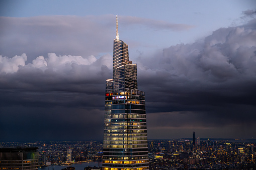 Scenic view of One Vanderbilt modern skyscrapers with shining glass mirrored facades and other architectural structures under cloudy sky cityscape in New York
