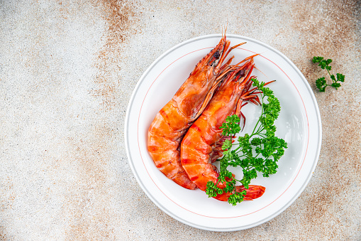 gambas langoustine large shrimp delicious prawns ready to eat healthy eating cooking appetizer meal food snack on the table copy space food background rustic top view Pescetarian diet