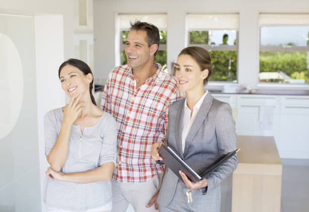 istock Real Estate Agent showing couple house 184312549