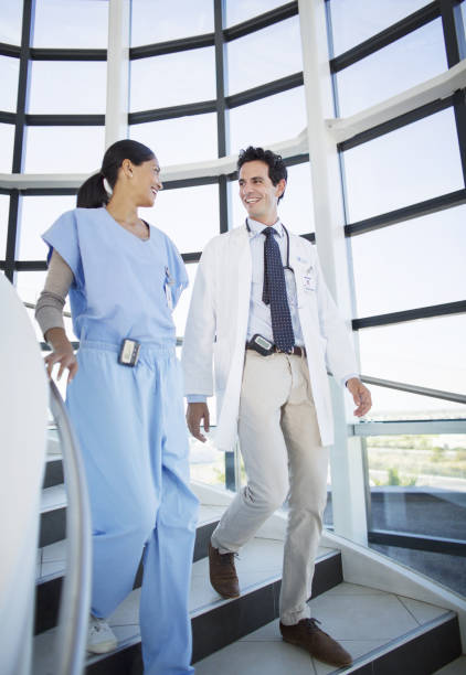 istock Doctor and nurse talking on staircase 184312601