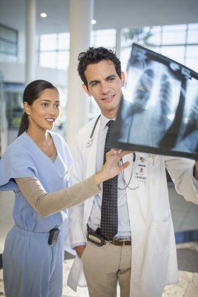 istock Doctor and nurse viewing head x-rays 184312644