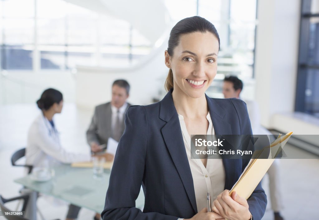 Portrait of smiling businesswoman in meeting with doctors  Hospital Stock Photo