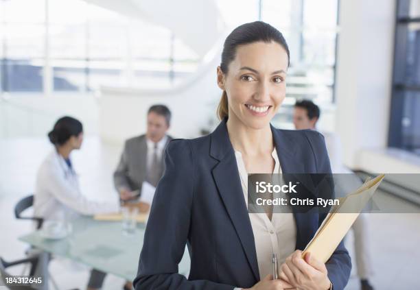 Portrait Of Smiling Businesswoman In Meeting With Doctors Stock Photo - Download Image Now