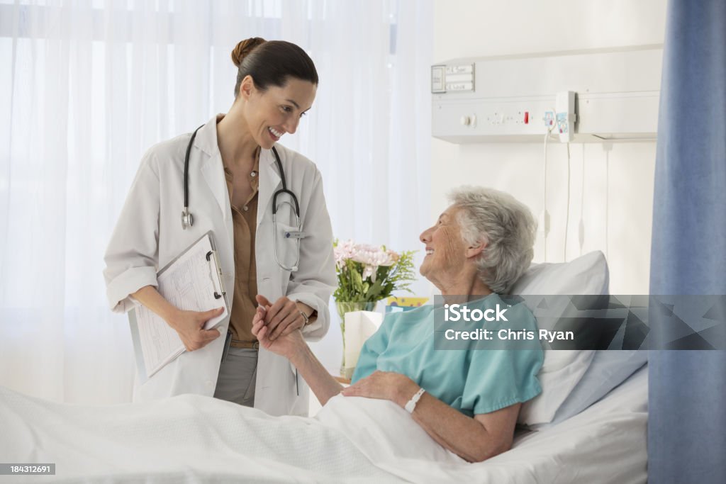 Doctor and senior patient talking in hospital room  Doctor Stock Photo