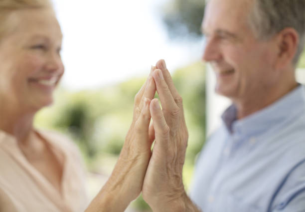 istock Senior couple touching hands on patio 184312786